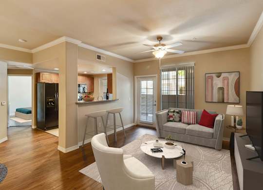 A living room with a grey couch, a coffee table, and a television. at Superstition Canyon Apartments, Apartments, Mesa, AZ