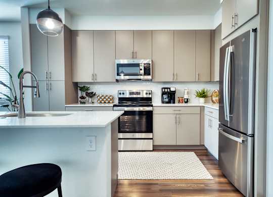 a kitchen with stainless steel appliances and white cabinets at Elevation at the Village, Gilbert, AZ 85295