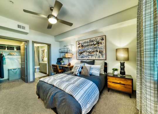 a bedroom with a bed and a ceiling fan at Elevation at the Village, Arizona, 85295