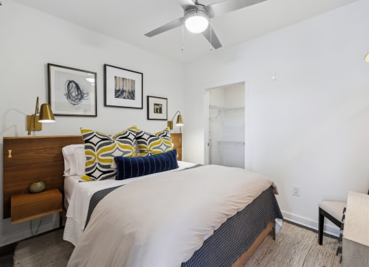 a bedroom with a large bed and a ceiling fan at Link Apartments® Broad Ave, Memphis, Tennessee