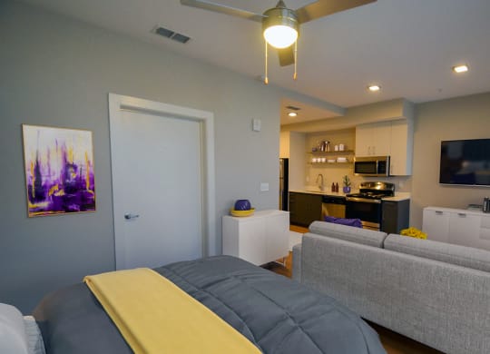 a bedroom with a bed and a couch at Link Apartments® Canvas, Atlanta, GA