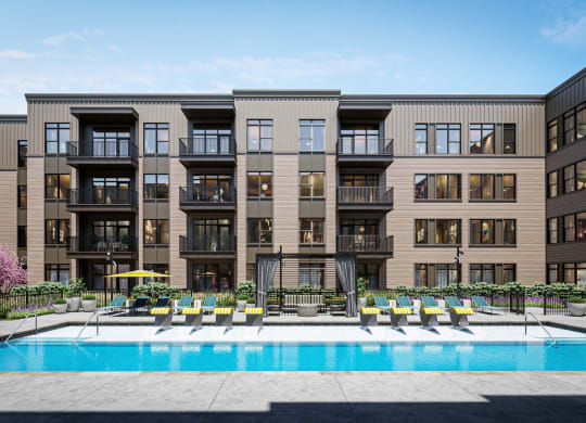 a swimming pool is in front of an apartment building at Link Apartments® Broad Ave, Memphis, TN