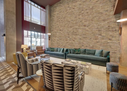 a living room with couches and chairs and a table at Link Apartments® Broad Ave, Memphis