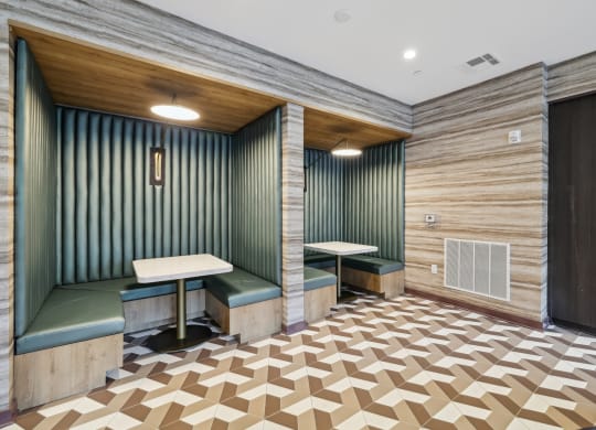 a tasting room with two booths and a wooden floor and green walls at Link Apartments® Broad Ave, Tennessee