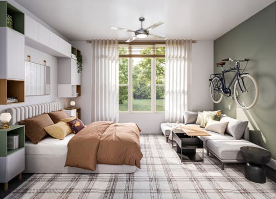 a bedroom with a bed and a couch and a ceiling fan at Link Apartments® CYKEL Apartments, Charlotte , 28208