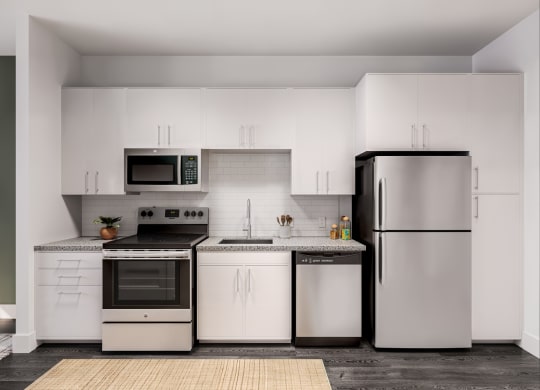 a kitchen with white cabinets and stainless steel appliances at Link Apartments® CYKEL Apartments, Charlotte , NC