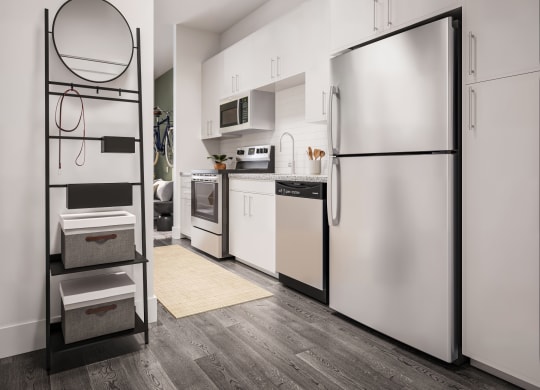 a white kitchen with white appliances and a stainless steel refrigerator at Link Apartments® CYKEL Apartments, Charlotte , NC 28208