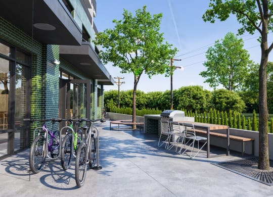 a patio with tables and bikes outside of a building at Link Apartments® CYKEL Apartments, Charlotte 