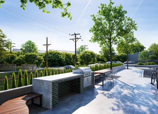 a seating area with benches and a barbecue grill on a city street at Link Apartments® CYKEL Apartments, North Carolina
