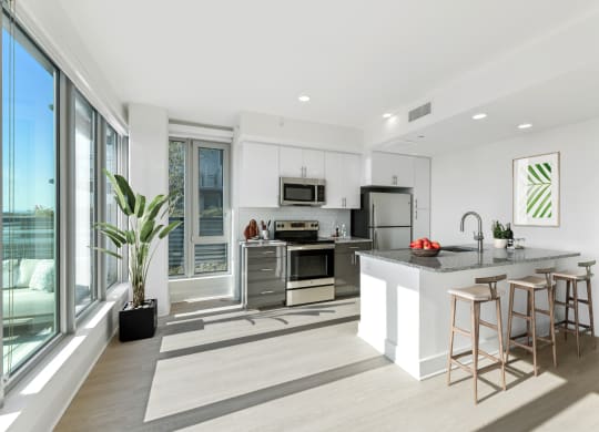 a kitchen with a large island and a large window  at Link Apartments® H Street, Washington