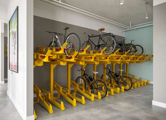 a large yellow bike rack with several bikes on it