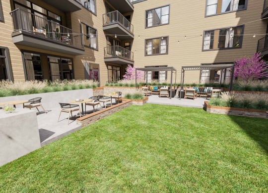 a patio with tables and chairs in front of an apartment building at Link Apartments NoDa 36th, Charlotte North Carolina