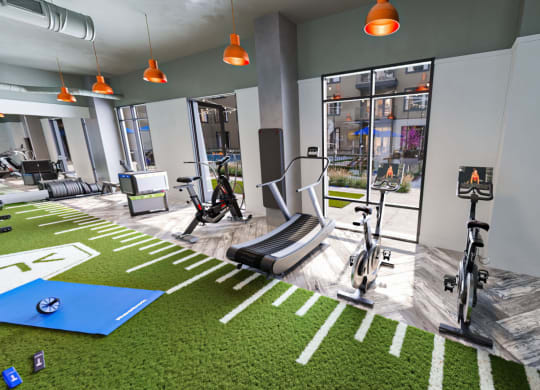a gym with green grass and exercise equipment at Link Apartments NoDa 36th, North Carolina