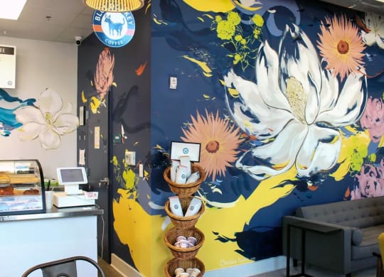 a mural of flowers on a blue and yellow background  at Link Apartments® Canvas, Atlanta