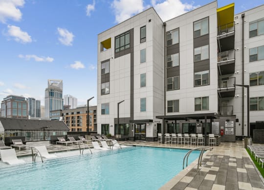a swimming pool in front of a building at Link Apartments® Mint Street, Charlotte