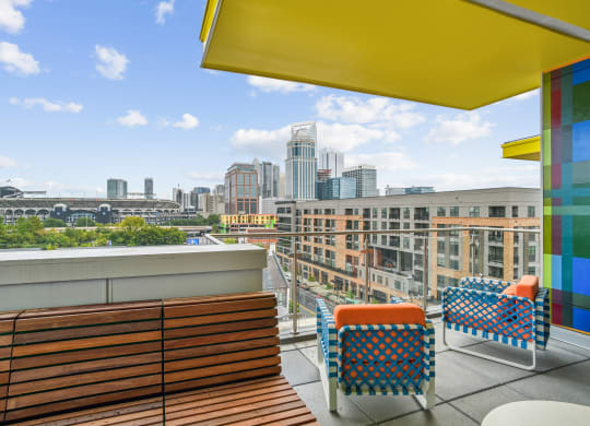 a rooftop terrace with chairs and a view of the city at Link Apartments® Mint Street, Charlotte, NC