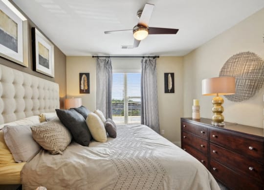 a bedroom with a large bed and a ceiling fan at Link Apartments® Brookstown, North Carolina