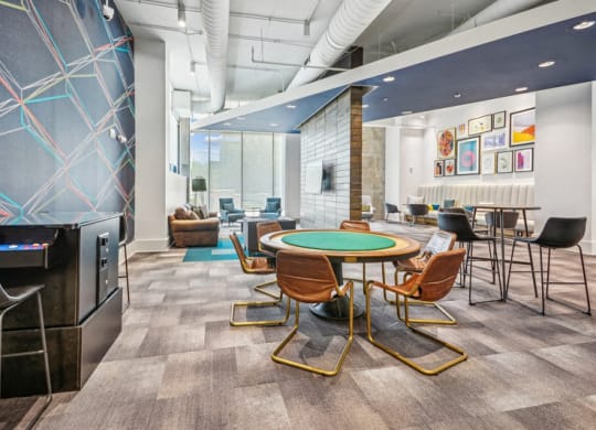 a room with a round table with chairs and a television at Link Apartments Innovation Quarter, North Carolina, 27101