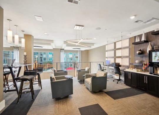 a living room with couches chairs and a bar and a television at Link Apartments® Brookstown, North Carolina, 27101