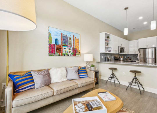 a living room with a couch and a kitchen at Link Apartments Innovation Quarter, Winston Salem, NC