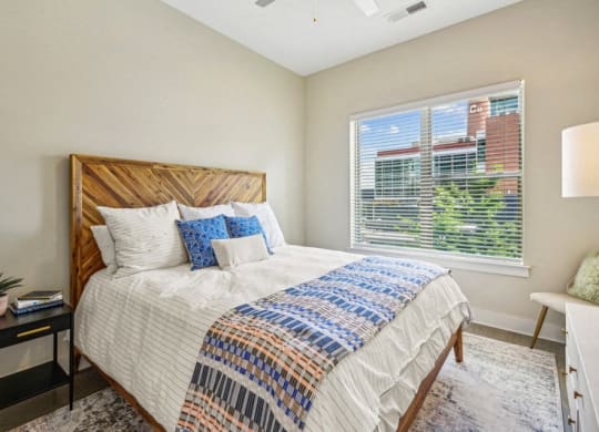 a bedroom with a large bed and a window at Link Apartments Innovation Quarter, Winston Salem, 27101
