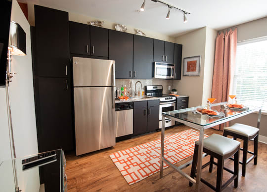 Fitted Kitchen With Island Dining at Link Apartments® Brookstown, Winston Salem, NC