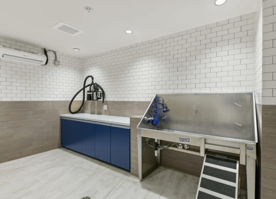 a kitchen with a stainless steel counter top and a sink  at Link Apartments® H Street, Washington