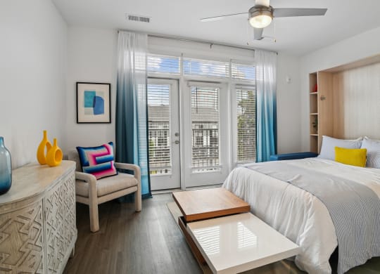 a bedroom with a bed and a sliding glass door at Link Apartments® Mint Street, Charlotte, North Carolina