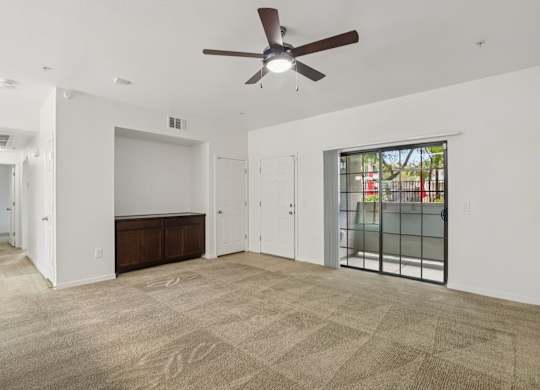 A room with a ceiling fan and carpeted floor. at Rome Park Villas, North Las Vegas, 89084