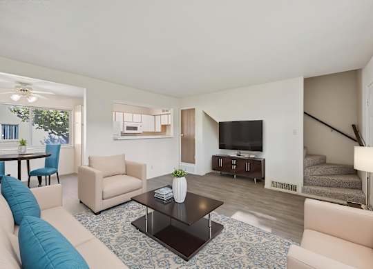 A living room with a blue couch and a television.