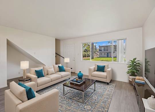 A living room with a couch, chair, and a coffee table.
