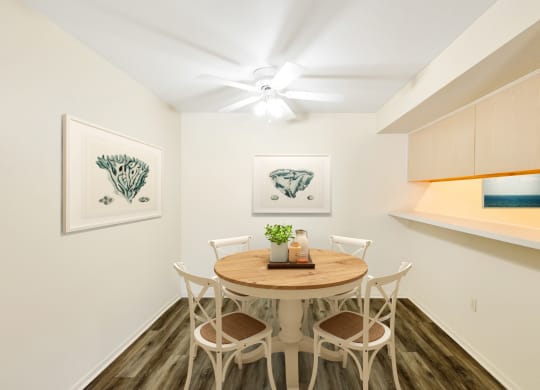 a dining room with a table and chairs and a ceiling fan