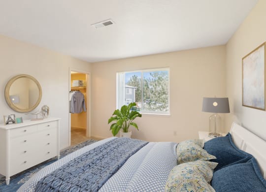 a bedroom with a bed and a dresser and a window