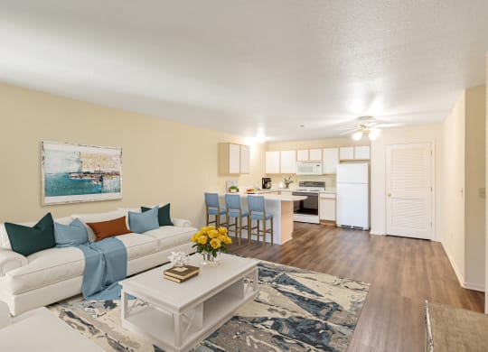 an open living room and kitchen with a white couch and table