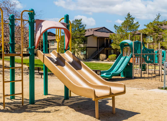 a playground with a slide and other playground equipment