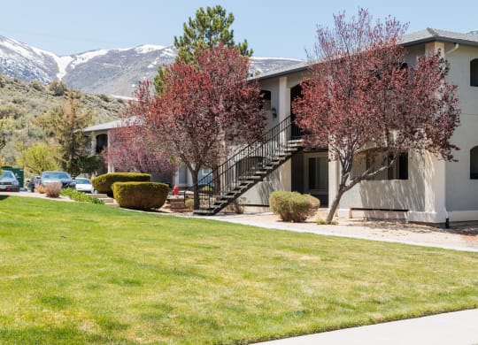 an apartment building with mountains in the background