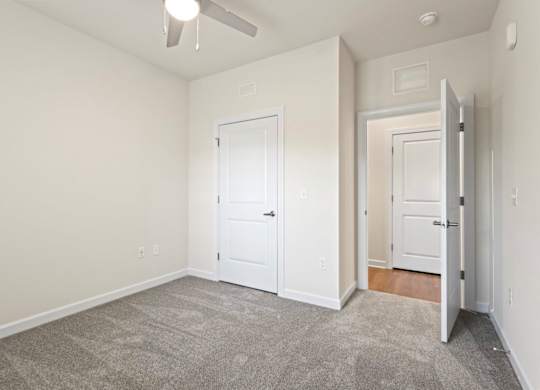 Peaks of Lexington Apartments Bedroom with Ceiling Fan, Light, Window and Gray Carpet