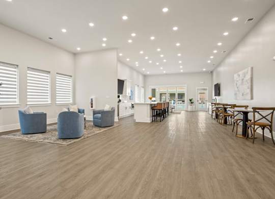 A spacious room with wooden floors and furniture.