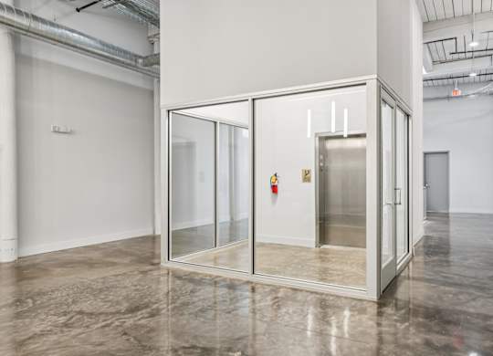 Elevator in glass room at Converse Mill Lofts in Spartanburg, SC