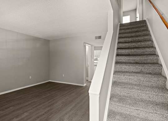 A room with a staircase leading to the upper floor.
