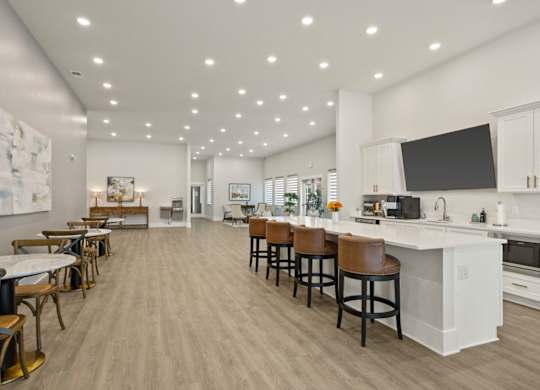 A modern kitchen with a bar area and a dining table.