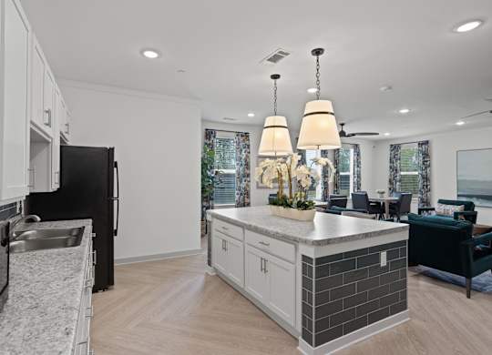Ovata at Reedy Creek Senior Apartments in Charlotte NC community kitchen with modern appliances and dining room tables