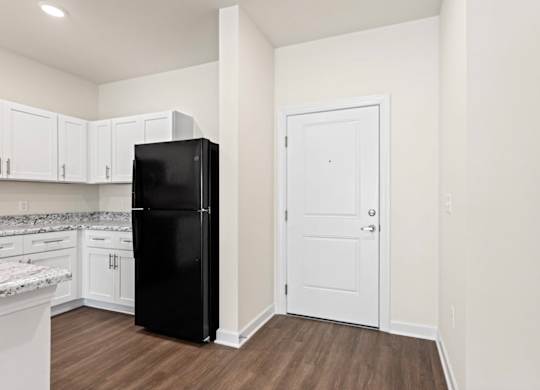 Peaks of Lexington Apartments Kitchen with Black Appliances, Granite Countertops and White Cabinetry