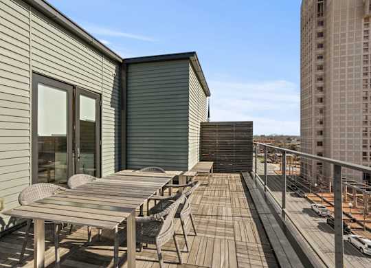 Upper floor terrace at Aug Smith on Main, above downtown, with tables.