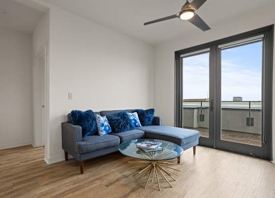 Aug Smith on Main living room with couch, coffee table and balcony overlooking Spartanburg, SC