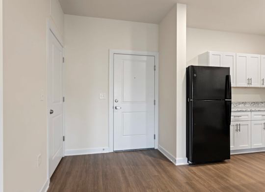 Peaks of Lexington Apartments Kitchen with Black Appliances, Granite Countertops and White Cabinetry