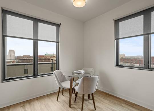 A room with a balcony at Aug Smith on Main, with a table and chairs.