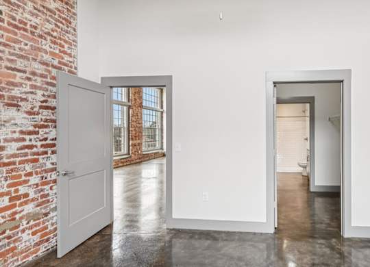View from bathroom in Converse Mill Lofts in Spartanburg, SC, with connected bathroom and view of the living room