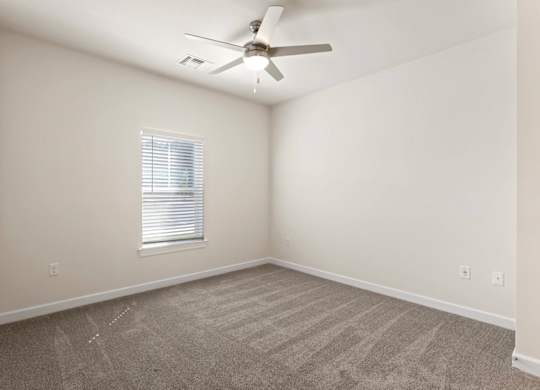 Peaks of Lexington Apartments Bedroom with Ceiling Fan, Light, Window and Gray Carpet