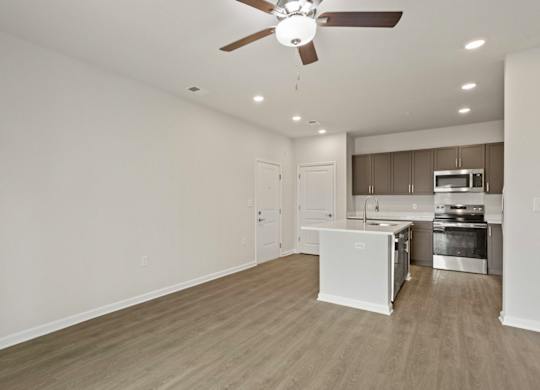 Grande at Geyser Falls Luxury Apartments Living Room and Kitchen with LVT Flooring